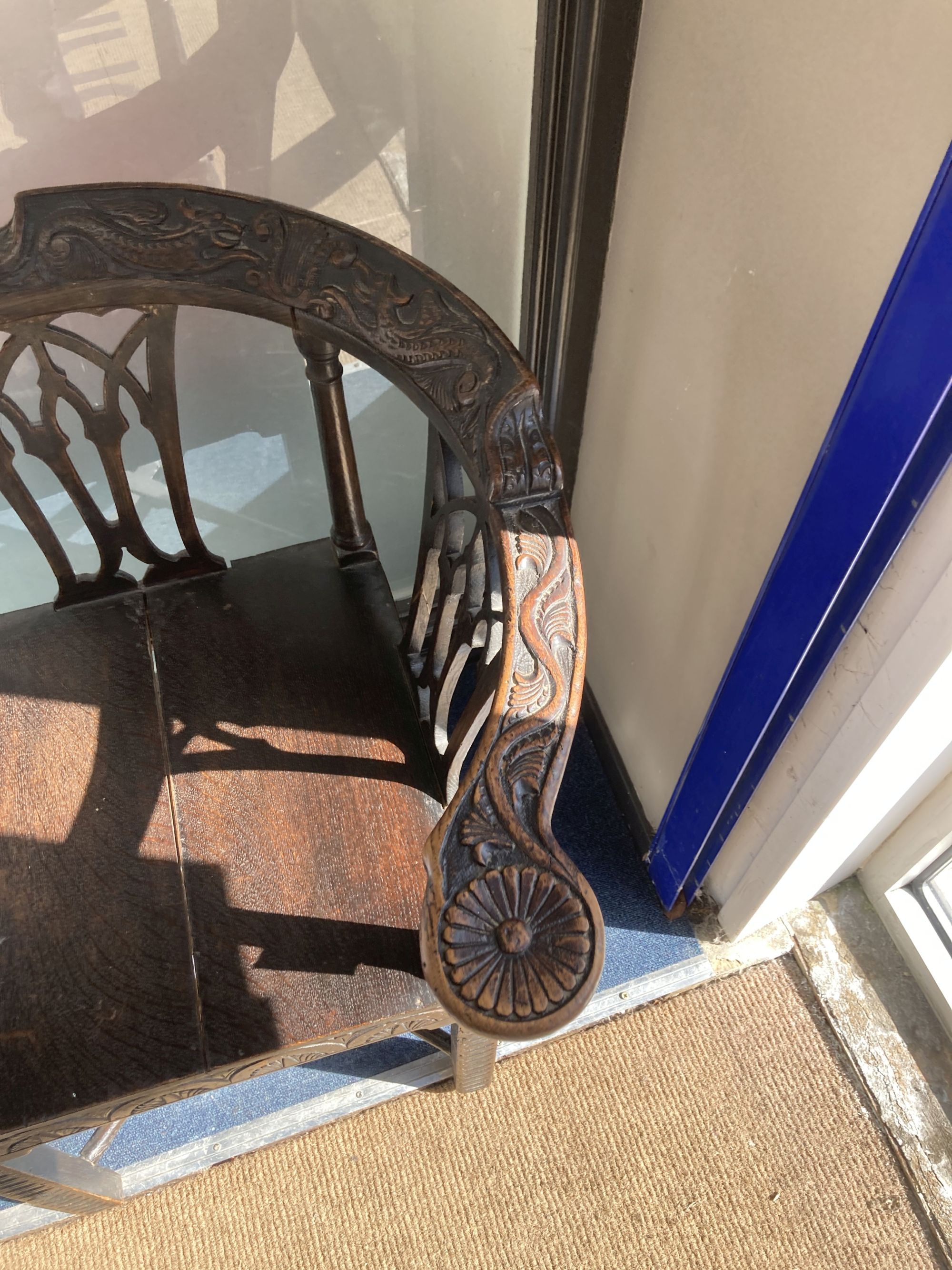 A George III carved mahogany corner elbow chair, width 76cm, depth 64cm, height 82cm